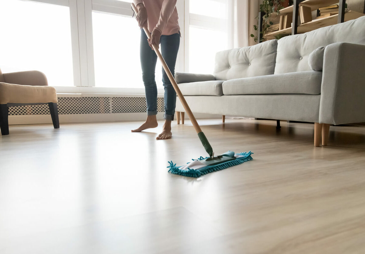 Woman mopping the living room floor