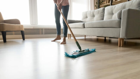 Woman mopping the living room floor