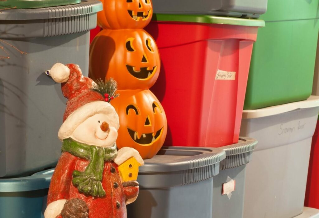 Colorful tote boxes next to a santa statue and pumpkin decor