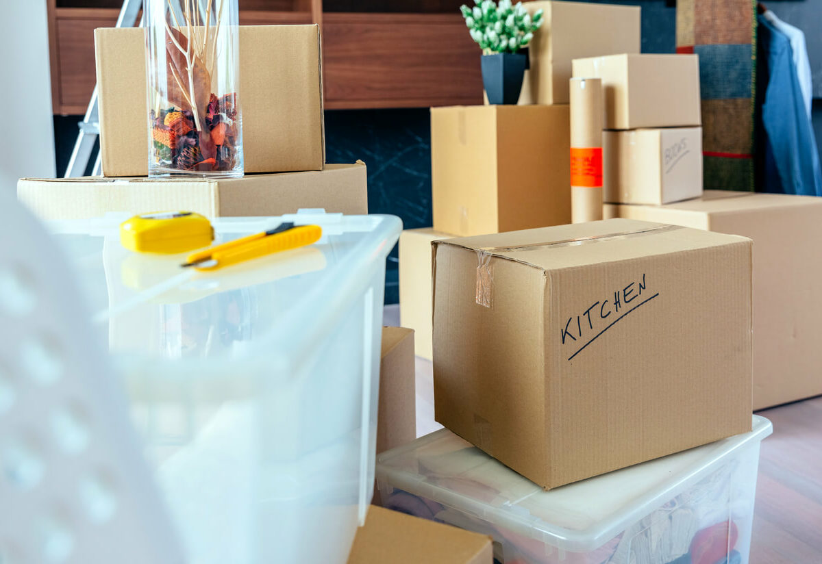 A living room filled with categorized boxes.