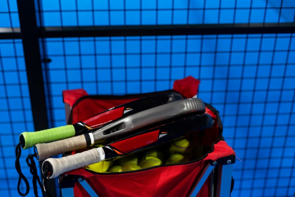 A shot of tennis equipment inside of a designated bag ready for storage.